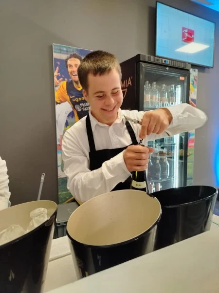 Un ragazzo del team Ape'n Down al lavoro al banco durante il servizio Hospitality di Hellas Verona